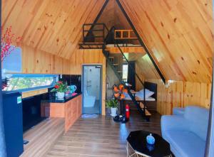 a living room with a staircase in a tiny house at Homestay Mộc Hoa Viên Bảo Lộc in Ấp Thiện Lập