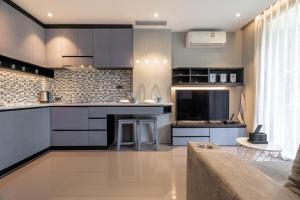 a kitchen with black cabinets and a counter top at Suite Celeste 1BR Sunset RooftopCitygate Kamala in Kamala Beach +27 photos