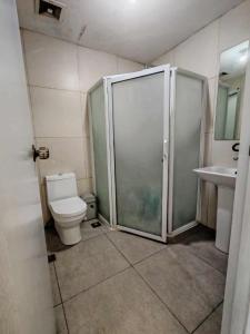 a bathroom with a shower and a toilet and a sink at Condotel in Baguio City in Baguio
