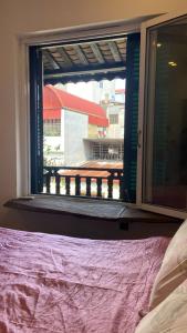 a bedroom with a window looking out at a picnic table at Phuong Maison d'Art in Hanoi