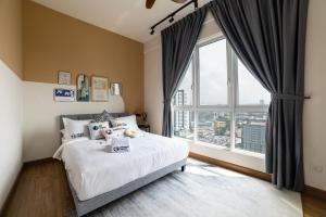 a bedroom with a bed and a large window at Plaza Kelana Jaya Suites by Sleepy Bear in Petaling Jaya +156 photos