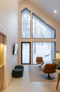 a living room with large windows at Villa QUU A, Superior 4BD detached Villa in Äkäslompolo