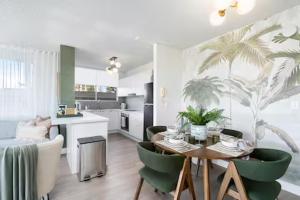 Una cocina y una sala de estar con mesa y sillas. en Beachfront Bliss 2BR Broadbeach, en Gold Coast