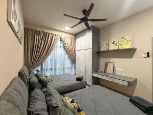a bedroom with a couch and a ceiling fan at MountAustin Projector 3BR 8pax NEW in Johor Bahru +29 photos