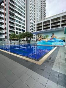 a large swimming pool in the middle of a building at MountAustin Projector 3BR 8pax NEW in Johor Bahru