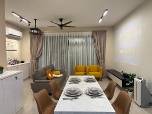 a kitchen and living room with a table and chairs at MountAustin Projector 3BR 8pax NEW in Johor Bahru