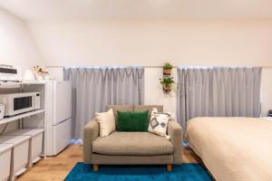 a living room with a chair and a bed at 小熊Annex 129Tb in Tokyo