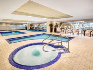 a swimming pool in the middle of a hotel lobby at Fairmont Vancouver Airport In-Terminal Hotel in Richmond