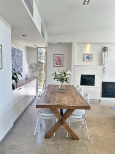 a kitchen and dining room with a wooden table and chairs at Charming Sandstone Villa in the heart of Norwood in Rose Park