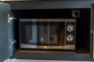 a microwave oven sitting on top of a counter at Luxury 1BR Apt Kamala Beach Resort B413 in Kamala Beach