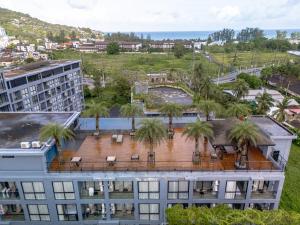 an aerial view of a building with palm trees at Luxury 1BR Apt Kamala Beach Resort B413 in Kamala Beach