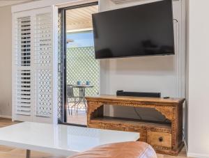 a living room with a flat screen tv on a wall at Tweed Coast Haven in Tweed Heads