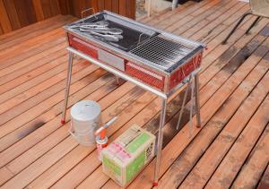 a grill sitting on top of a wooden deck at 日は沈みまた昇る in Nirasaki