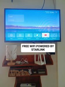 ein Flachbildfernseher auf einem Regal in der Unterkunft Virginia Homestay 1North Siargao in Burgos