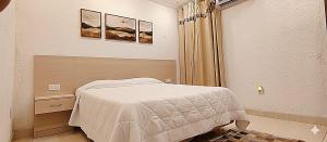 a small bedroom with a bed in a room at Beautiful House - COP30 in Belém