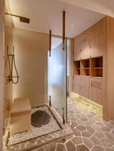 a bathroom with a shower and a bench in it at Metrolux City Contemporary Hotel in Ho Chi Minh City +118 photos
