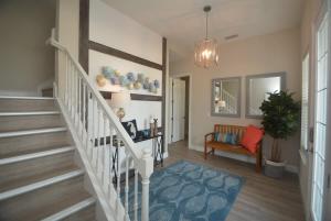 una escalera en una casa con una alfombra azul en Beachside Home Heated Swim Spa Fenced Yard, en Marineland