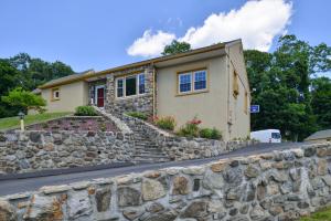 a stone retaining wall in front of a house at Golden Hill Inn-Danbury in Danbury