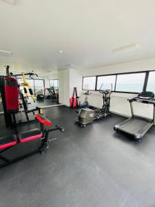a gym with several treadmills and exercise bikes at San Miguel Apartment Vista Mar in Lima