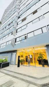 a large white building with glass windows at San Miguel Apartment Vista Mar in Lima