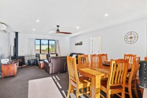 a dining room and living room with a table and chairs at 130 Jacks Pass Road in Hanmer Springs