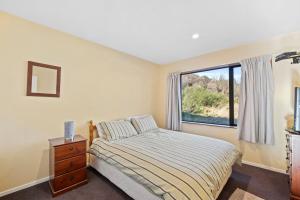 a bedroom with a bed and a window at 130 Jacks Pass Road in Hanmer Springs