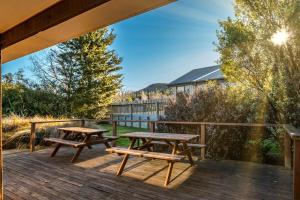 two picnic tables on the deck of a house at 130 Jacks Pass Road in Hanmer Springs