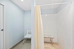 a room with a shower curtain and a bench at 130 Jacks Pass Road in Hanmer Springs +15 photos