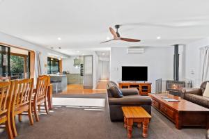 a living room with a couch and a tv at 130 Jacks Pass Road in Hanmer Springs