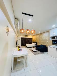 a kitchen and living room with a table and a couch at Luxury Summer Suites KLCC By LEXA Stay in Kuala Lumpur