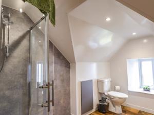 a bathroom with a toilet and a glass shower at Crannoch Self Catering in Buckie +75 photos