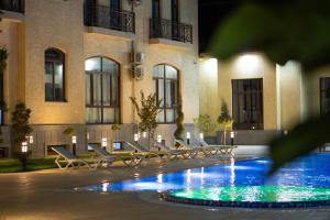 a pool in front of a building at night at Air Plaza in Samarkand