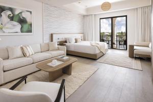 a living room with a couch and a bed at Taribans Haven in Kalimoni