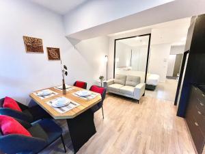 a living room with a table and chairs and a couch at Modern apartment in the city center in Auckland