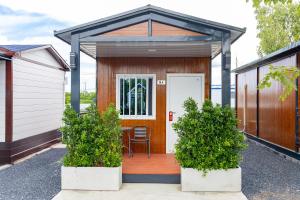 a tiny house with a porch with a table and chairs at Air diamond resort in Ban Nong Bon +5 photos