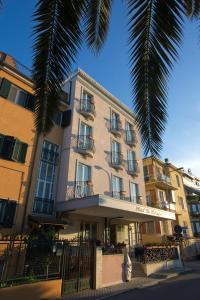 a building with a palm tree in front of it at Hotel La Palazzina in San Benedetto del Tronto