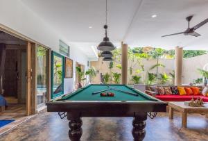 a pool table in a living room with a couch at Villa Josefine, 5 Bedroom pool, rooftop, pool table in Seminyak