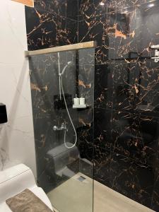 a bathroom with a black and gold marble wall at Alloro Boutique Hotel Pacitan in Pacitan +48 photos