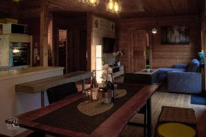 a kitchen and living room with a table in a room at Holzblockhaus, Eifel in Oberkail