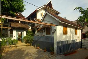 a white house with a fence in front of it at The Mundanad House in Trivandrum