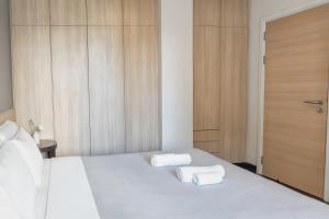 a bedroom with a bed with two towels on it at Taweewan Place Bangkok in Bangkok