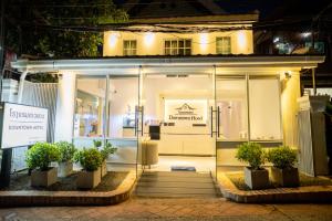 a store front with potted plants in front of it at DownTown Hotel in Luang Prabang