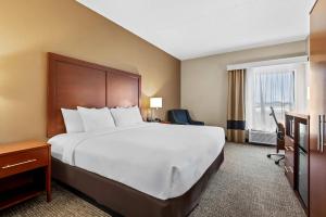 a hotel room with a large bed and a window at Comfort Inn Chambersburg North in Chambersburg +32 photos