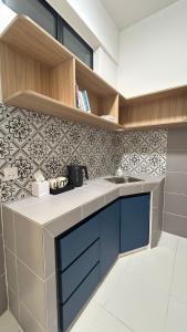 a kitchen with a sink and a tile wall at StudioMimi Near UTP UiTM Seri Iskandar in Seri Iskandar +15 photos
