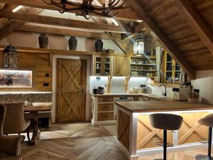 a kitchen with wooden cabinets and a table and a barn door at Deer Apartment in Lipí