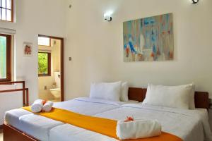 Ένα ή περισσότερα κρεβάτια σε δωμάτιο στο Tropical Terrace Negombo +79 φωτογραφίες