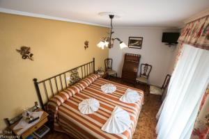 a bedroom with a bed with pillows on it at Hostal Camino de Santiago in Frómista