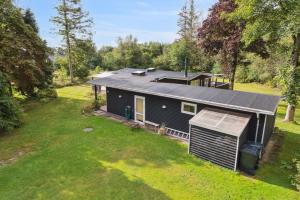 an aerial view of a house with a yard at Renovated Holiday Home Near Water And Nature in Lundø