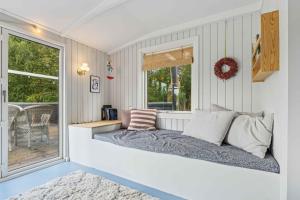 a bed in a room with a window at Renovated Holiday Home Near Water And Nature in Lundø