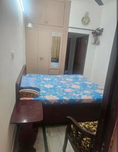 a small bedroom with a bed and a chair at Hotel nitin in McLeod Ganj